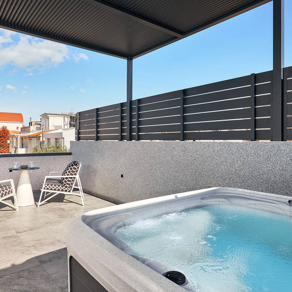 Grey Stones Villa Ammoudara Room1 balcony with small table, two chairs and jacuzzi