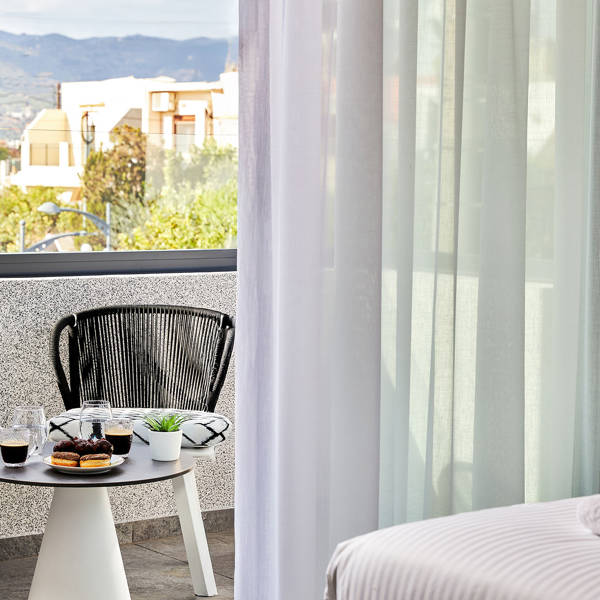 Grey Stones Villa Ammoudara Room2 balcony view with small decorated table and two chairs